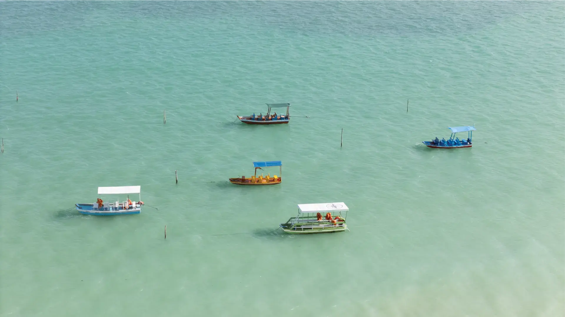 Barcos coloridos em um mar de águas claras