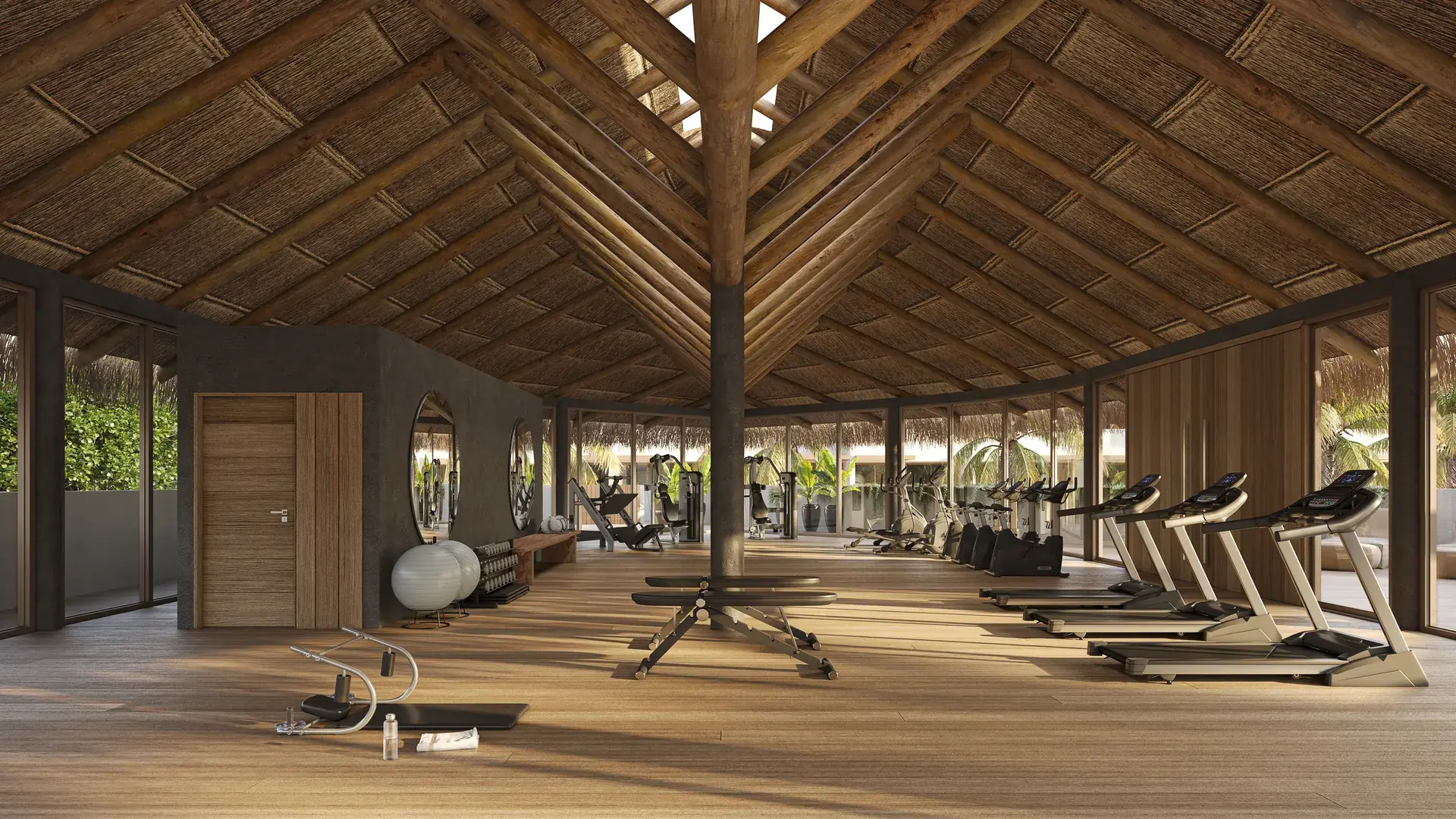 Academia com piso de madeira, esteiras, bicicletas ergométricas e outros aparelhos